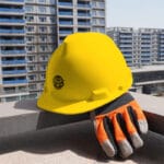 Wokin Safety Helmet on a construction site ledge with work glove