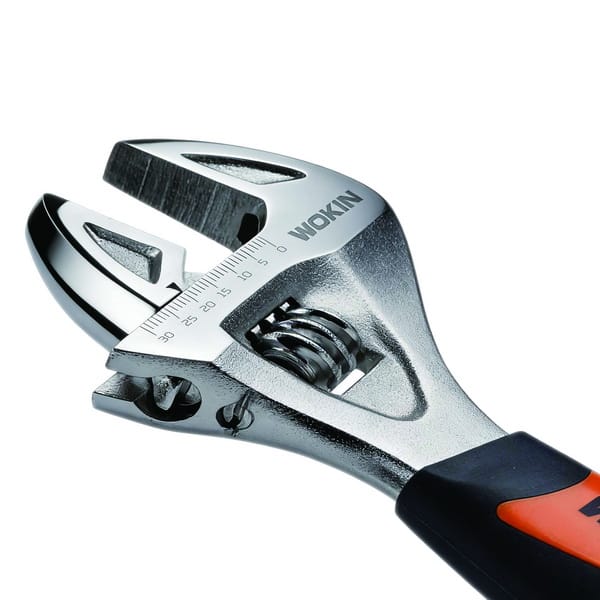 Close-up detail of WOKIN stubby adjustable wrench jaw showing laser-etched metric measurement scale.