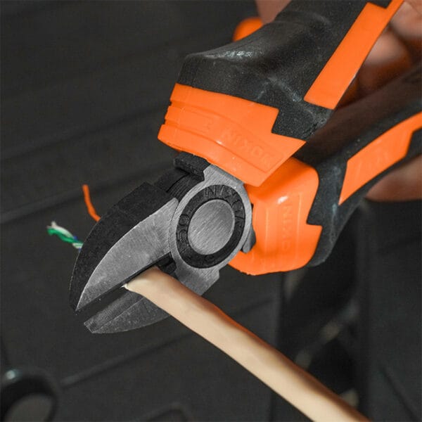 A close-up shot shows Wokin diagonal cutting pliers from the Wokin 98pcs tool chest set cutting a beige-colored electrical wire.