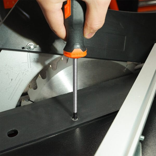 Using a screwdriver from the Wokin 98pcs tool chest set on a saw blade assembly