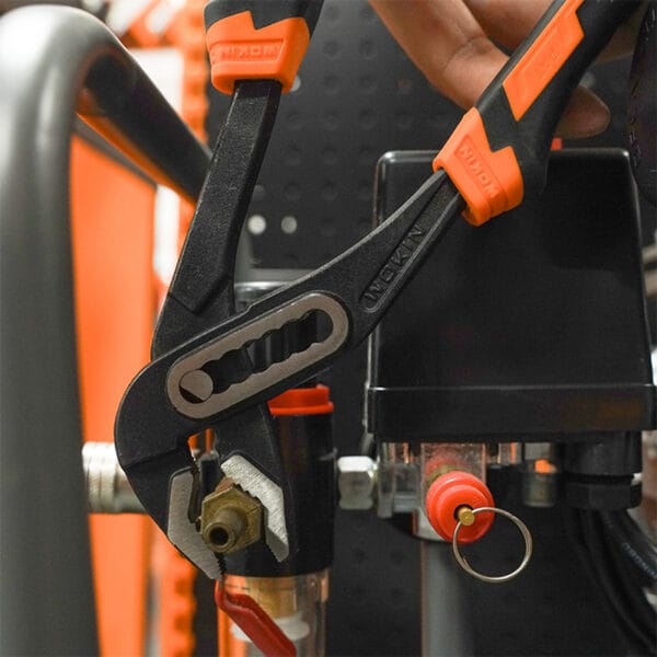 Using a water pump pliers from the Wokin 98pcs tool chest set on a pipe fitting