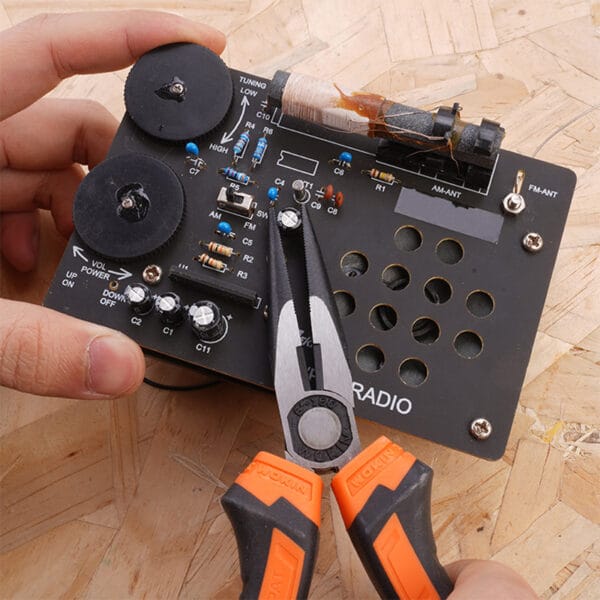 Using diagonal cutting pliers from the Wokin 98pcs tool chest set to Clamp a knob on a circuit board