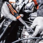 Using a ratchet from the Wokin 163pcs roller cabinet tools set on an engine component