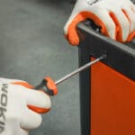 Using a screwdriver from the Wokin 163pcs roller cabinet tools set on a screw