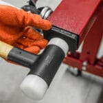 Using a soft-faced mallet from the Wokin 163pcs roller cabinet tools set on machinery