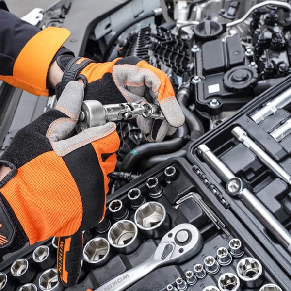 Close-up of hands wearing WOKIN gloves using WOKIN ratchet and socket to tighten a bolt on a car engine component