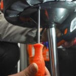 Using a screwdriver from the Wokin 4Pcs Screwdrivers Set on chair