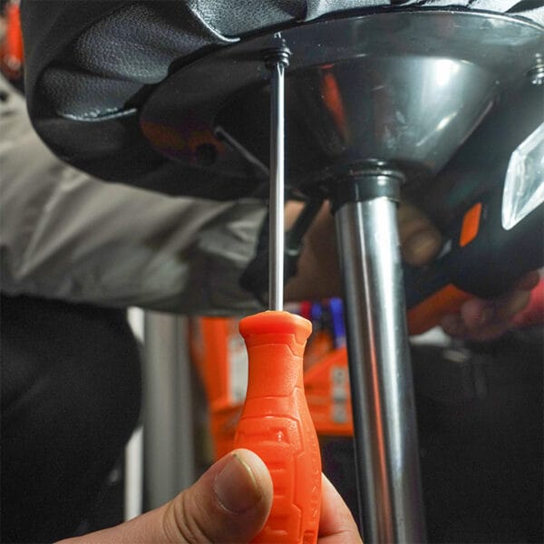 Using a screwdriver from the Wokin 4Pcs Screwdrivers Set on chair