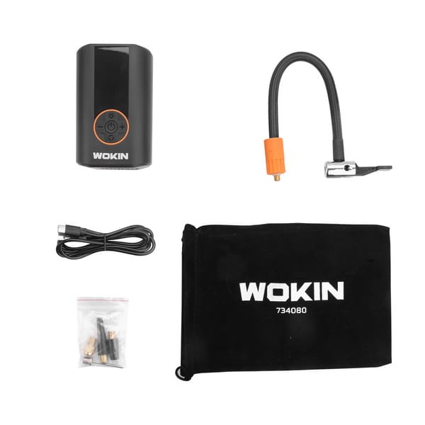 Full kit contents of WOKIN portable tire inflator including the main unit, air hose, USB charging cable, valve adapters, and velvet storage pouch.