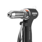 Close-up view of the silver nosepiece and interchangeable rivet nozzle on the WOKIN air riveter, designed for precision setting of blind rivets.