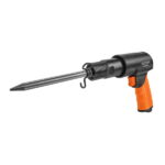 Side profile of the WOKIN pneumatic air hammer ready for use, featuring a pointed chisel secured by a black coil retainer spring and an orange ergonomic grip.