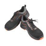 A pair of WOKIN lightweight athletic-style safety sneakers, featuring a breathable black knit upper with dynamic orange accents and secure laces.